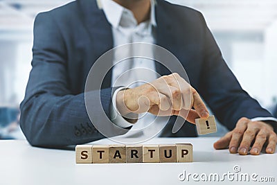 New startup business plan concept - young businessman connecting wooden blocks in office Stock Photo