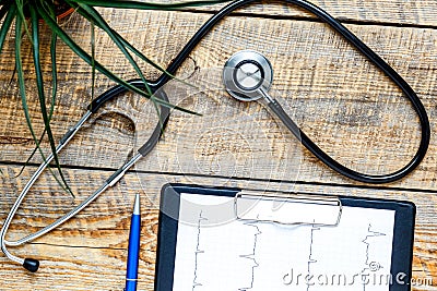 new stethoscope on wooden table with cardiogram Stock Photo