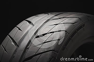 New summer directional tire for sports car racing and drift. close- up on a black background Stock Photo