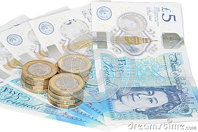 The new UK polymer five pound note and the new 12 sided Â£1 coin Editorial Stock Photo