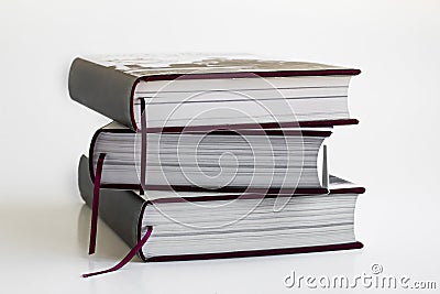 New, unused,hard cover books stacked on white surface Stock Photo