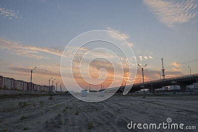 New Urengoy, YaNAO, North of Russia. September 1, 2017. Sundown and sunrises. Orange sky and much clouds. Bridge in the city stree Editorial Stock Photo