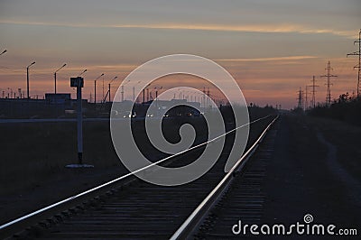 New Urengoy, YaNAO, North of Russia. September 30, 2017. Sundown and sunrises. Railroad in the summer evening going far away. Dark Editorial Stock Photo