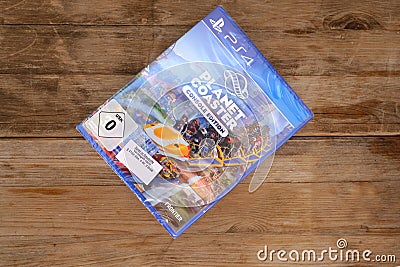 new virtual console game Planet Coaster, Park Simulator, Console Edition for PlayStation on wooden table, unique roller coaster Editorial Stock Photo
