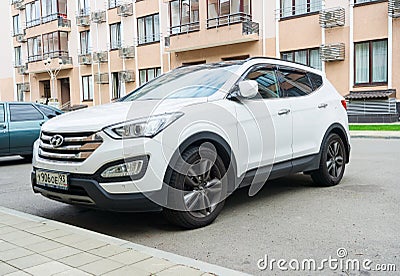 New white Hyundai Santa Fe parked on the street near the house. Editorial Stock Photo
