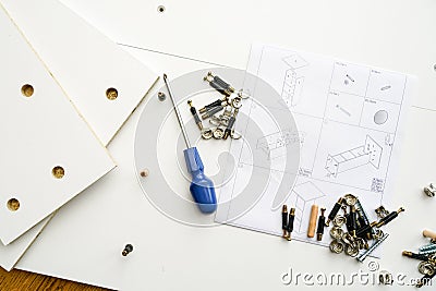 New white laminated chipboard furniture self mounting set with fitting kit and assembly diagram Stock Photo