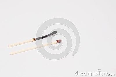 A new whole match and burned out match. Stock Photo