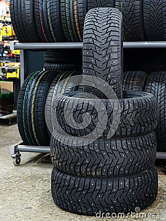New winter tire set with studs at tire shop Stock Photo