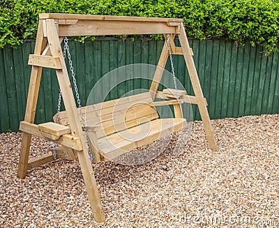 New wooden garden swing bench Stock Photo