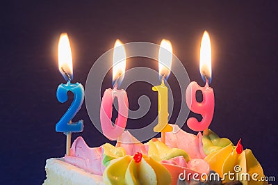 New Year 2019. Burning festive candles on cake close-up Stock Photo