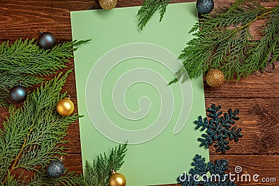 New Year card. Cypress branches, paper blank, balls, snowflakes, on wooden background Stock Photo