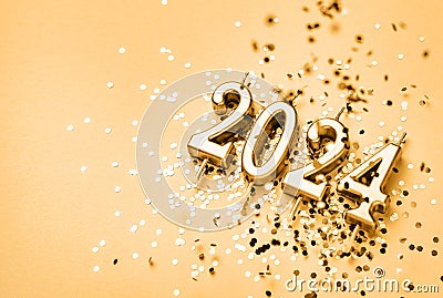 New Year 2024 celebration festive background made with golden candles in the form of number two thousand twenty four Stock Photo