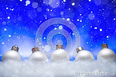 New Year and Christmas background. White Christmas toys lie in the snow, with a bright background. Falling snow. Christmas Stock Photo