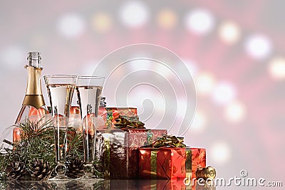 New Year and Christmas celebration. Champagne, two wine glasses, fireworks and gifts Stock Photo