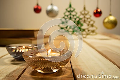 New year and Christmas compositions background with aroma candle,books and decoration Christmas ball on the table wooden Stock Photo