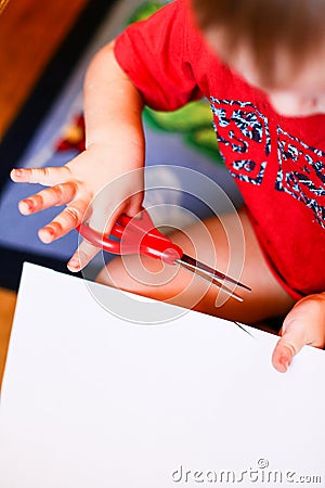 New Year/Christmas concept - a boy cutting paper snoflakes Stock Photo
