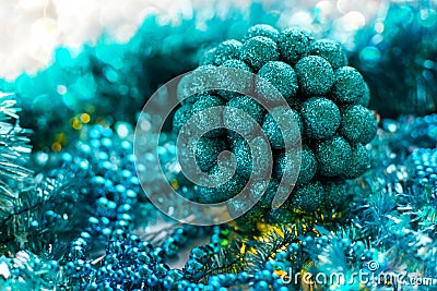 Beautiful Christmas ball on the background of turquoise-colored garlands and tinsel. Stock Photo
