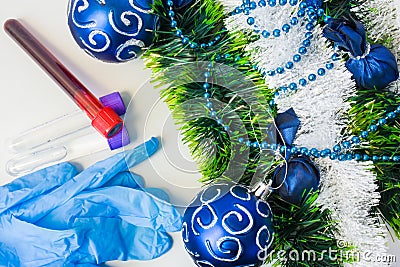 New Year and Christmas in medical, clinical or scientific laboratory. Protective gloves and laboratory test tubes with blood sampl Stock Photo