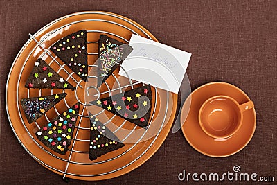 New year and Christmas trees gingerbread (ginger and honey cookie, decorated with colored powder. Stock Photo