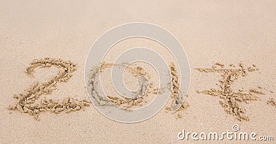 New Year 2017 is coming concept - inscription 2017 on a beach sand Stock Photo