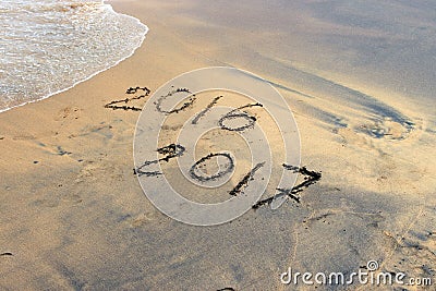 New Year 2017 is coming concept - inscription 2016 and 2017 on a beach sand Stock Photo