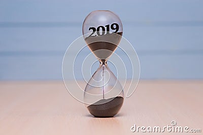 New Year 2019 concept. Time running out concept with hourglass falling sand Stock Photo