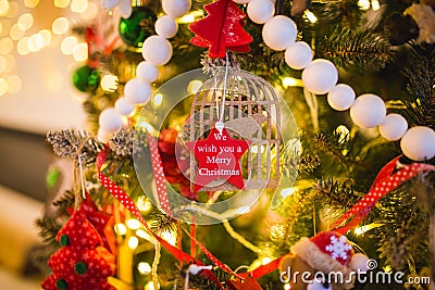 New Year decoration in the form of a red star on a Christmas tree with the inscription we wish you a merry christmas Stock Photo