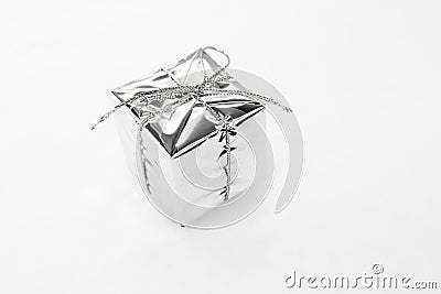 New year decoration - silver small gift, square shiny reflection toy on white background. Christmas concept Stock Photo