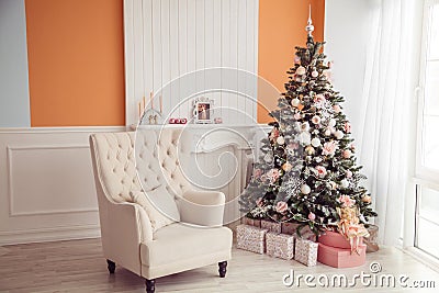 New Year interior with armchair and christmas tree. Pink and ora Stock Photo