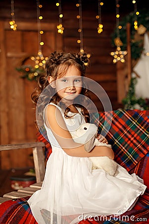 New Year 2020. Merry Christmas, happy holidays. Close-up portrait of a little girl Magic Light in Night Xmas Tree Interior Stock Photo
