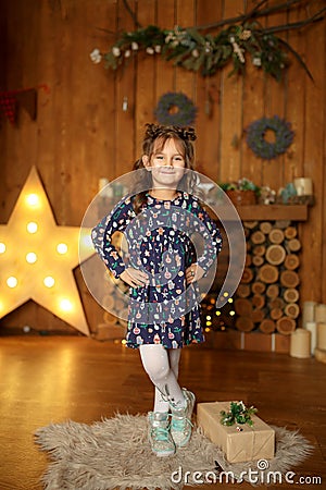 New Year 2020. Merry Christmas, happy holidays. A little girl Magic Light in Night Xmas Tree Interior Stock Photo