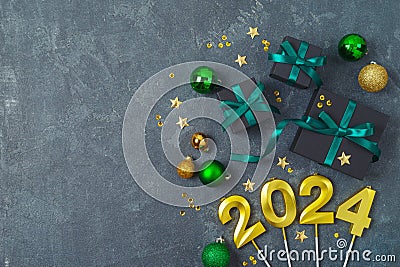 New Year 2024 party background with decorations and black gift boxes. Top view, flat lay Stock Photo