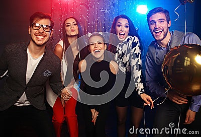 New year party, holidays, celebration, nightlife and people concept - Young people having fun dancing at a party Stock Photo