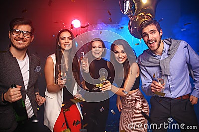 New year party, holidays, celebration, nightlife and people concept - Young people having fun dancing at a party Stock Photo