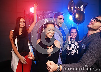 New year party, holidays, celebration, nightlife and people concept - Young people having fun dancing at a party Stock Photo