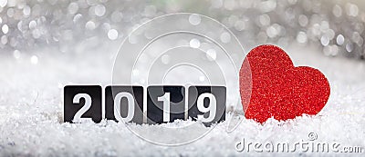 New year 2019 and a red heart on snow, abstract bokeh lights Stock Photo