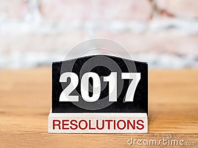 New year 2017 resolutions text on blackboard sign on wood table Stock Photo