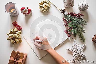 New year resolutions written with a hand on notebook with new years deco Stock Photo