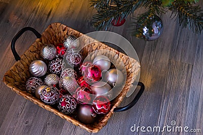 New year`s background. Christmas composition with basket, red and silver balls, a gray background. Christmas card. Stock Photo