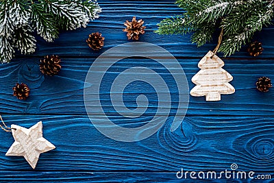 New year`s background. Christmas toys, spruce branches, pine cone on blue wooden background top view copyspace Stock Photo