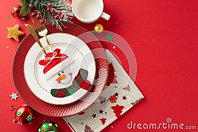 Top view image showcasing adorable plate setting, gold cutlery in special pocket, mug, napkin, baubles Stock Photo