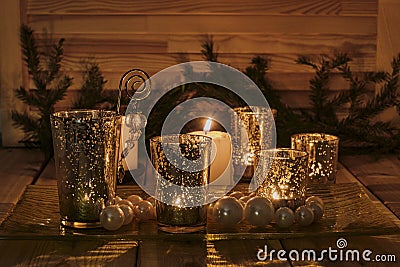8New Year's or Christmas evening composition on the windowsill. Burning candles, golden candlesticks Stock Photo
