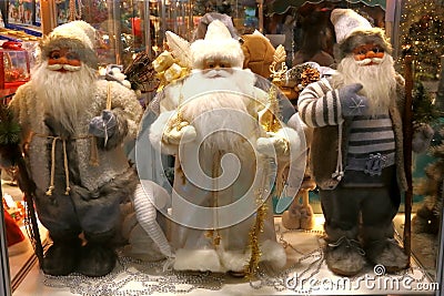 New Year`s and Christmas. Three Santa Claus in the shop window o Stock Photo