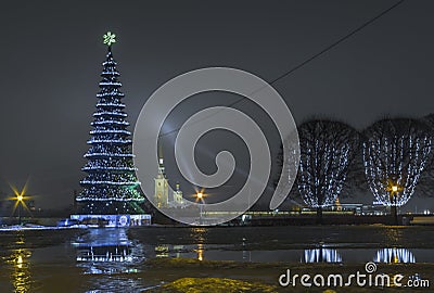 New Year`s Christmas tree and New Year`s garlands on the trees in the Stock Square on Strelka of the Vasilyevsky Island in St. Pet Editorial Stock Photo