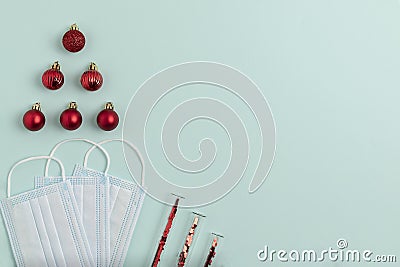 New Year`s composition of three masks, New Year`s red balls lying in the shape of a Christmas tree and test tubes with sparkles Stock Photo