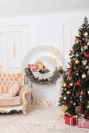 New Year`s decor in the room with a Christmas tree, a fireplace and gifts Stock Photo