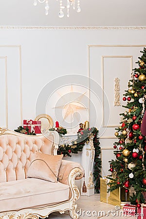 New Year`s decor in the room with a Christmas tree, a fireplace and gifts Stock Photo