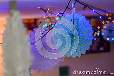 New year`s decoration with lamps and paper rosettes Stock Photo