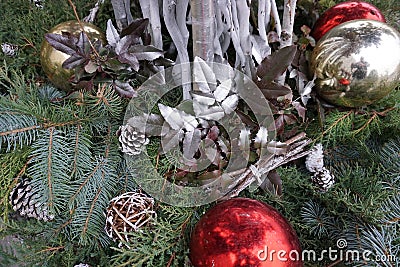 New Year`s decoupage made from balls, cones, painted branches with leaves and green spruce branches Stock Photo
