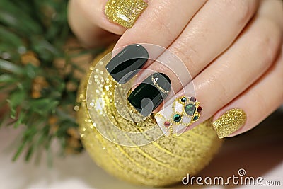 New year`s fashionable beautiful festive manicure on short square nails with green lacquer color. Stock Photo